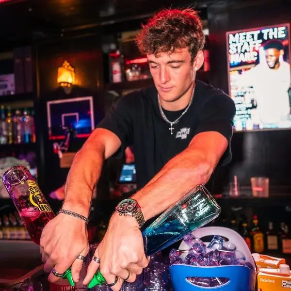 Bartender pouring drinks behind the bar