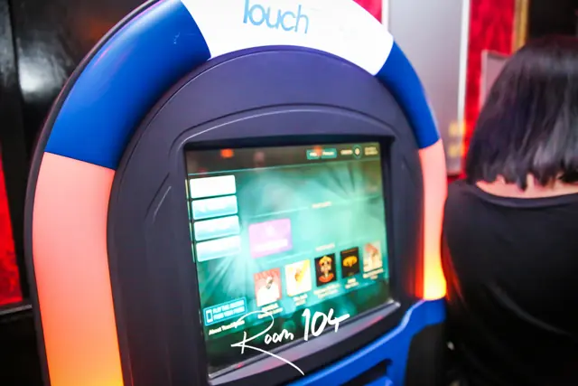 Touchscreen jukebox lit up at Room 104